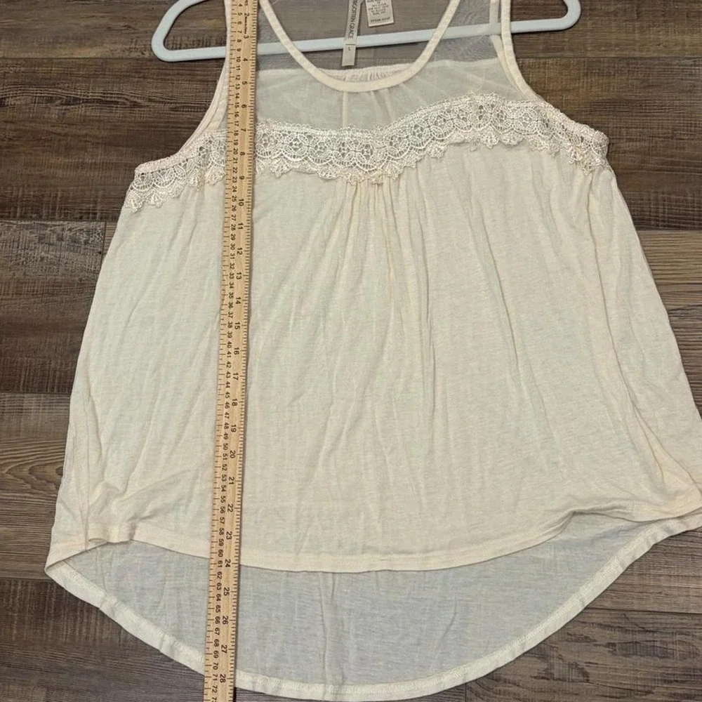 Cream lace tank top with sheer mesh and lace trim on the shoulders